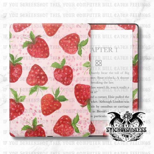 a pink cover with a repeating pattern of red strawberries and green leaves. The cover appears to be a book cover or a tablet case with a strawberry design.